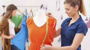 woman measuring orange clothes