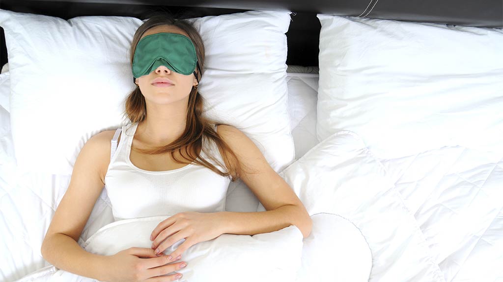 woman sleeps with blindfod over her eyes