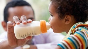 toddler drinking from a bottle