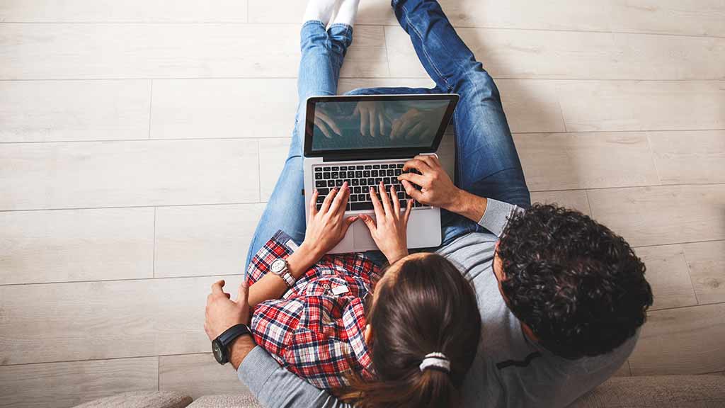 couple searching on laptop