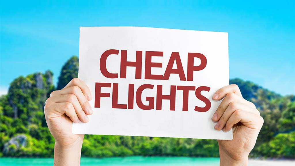hands holding cheap flights sign flight comparator