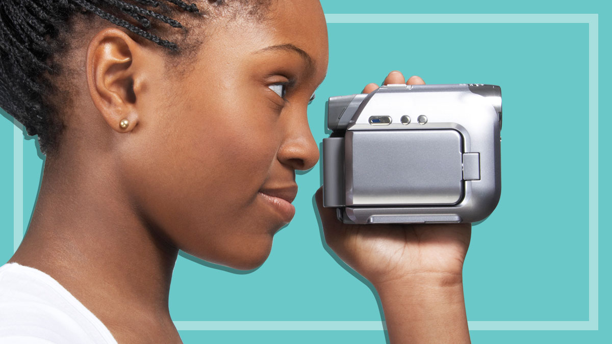 young woman holding video camera