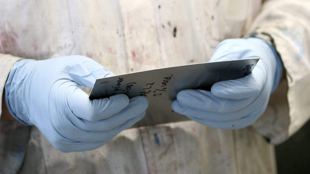lab worker checking paint sample