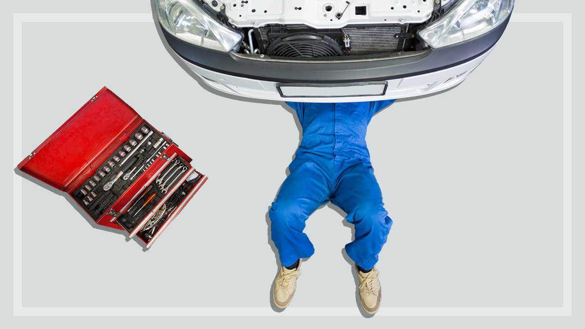 mechanic_under_front_of_car_doing_service
