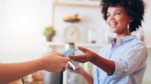 woman taking card for payment at a cafe