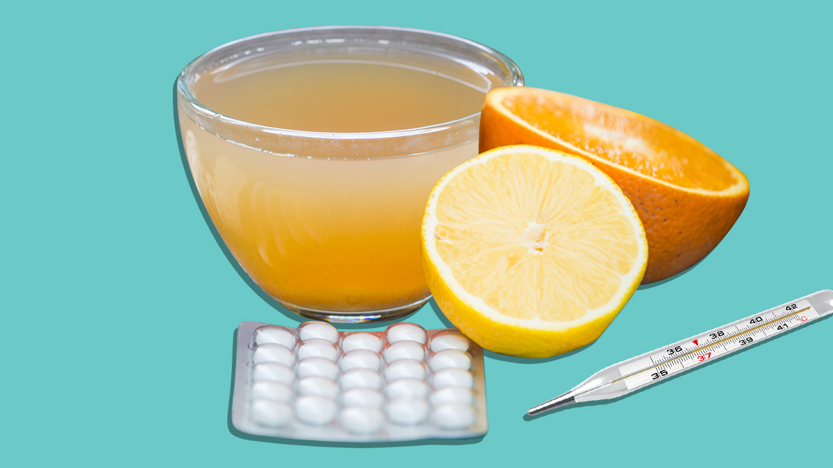 hot lemon drink with aspirin, lemon and thermometer