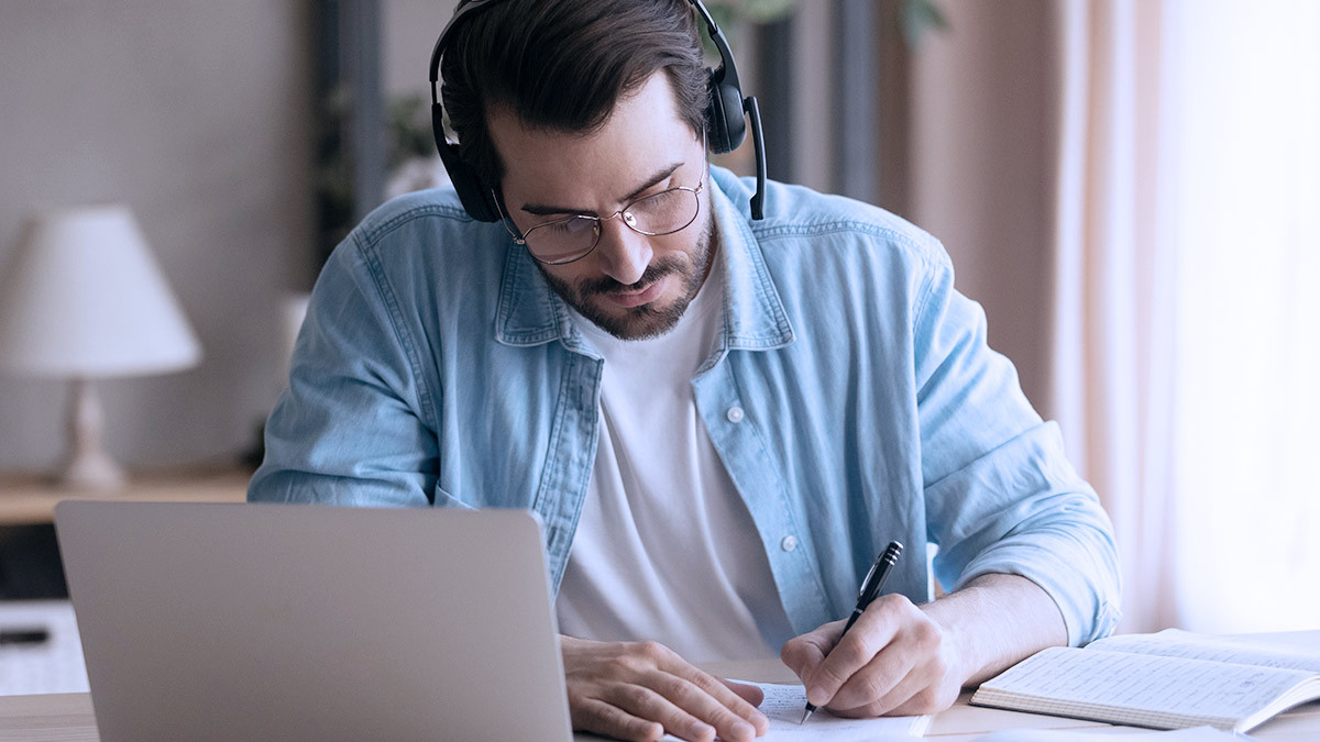 man using a headset while sitting at a desk
