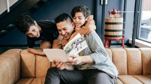 Father and sons looking at a photo book