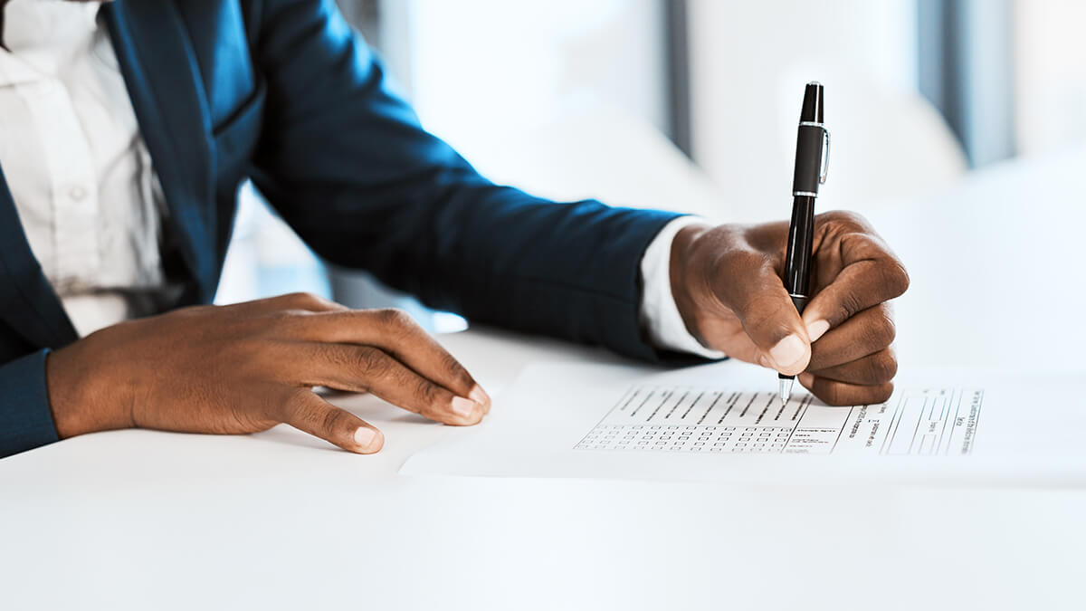 man signing a legal contract