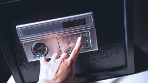 person entering code on home safe