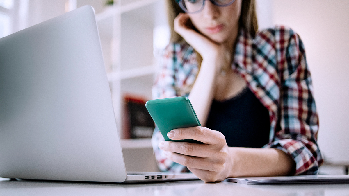 young_person_checking_social_media_on_smartphone