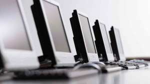 row of desktop computer screens