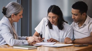 young_couple_signing_financial_document