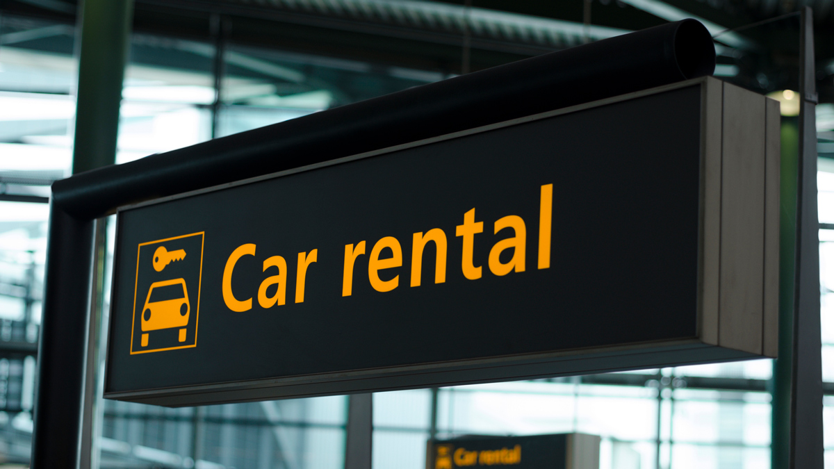 car rental sign at an airport