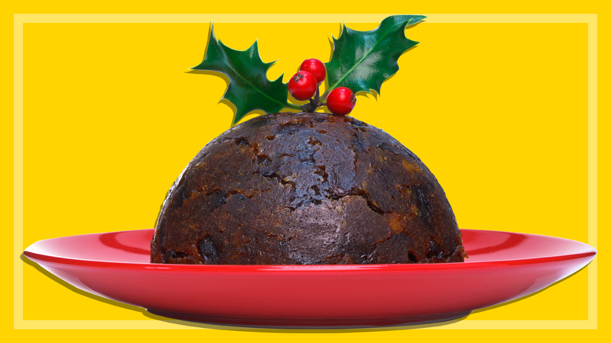 traditional Christmas pudding on a red plate on a yellow background