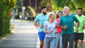 a group of men and women jogging outside together