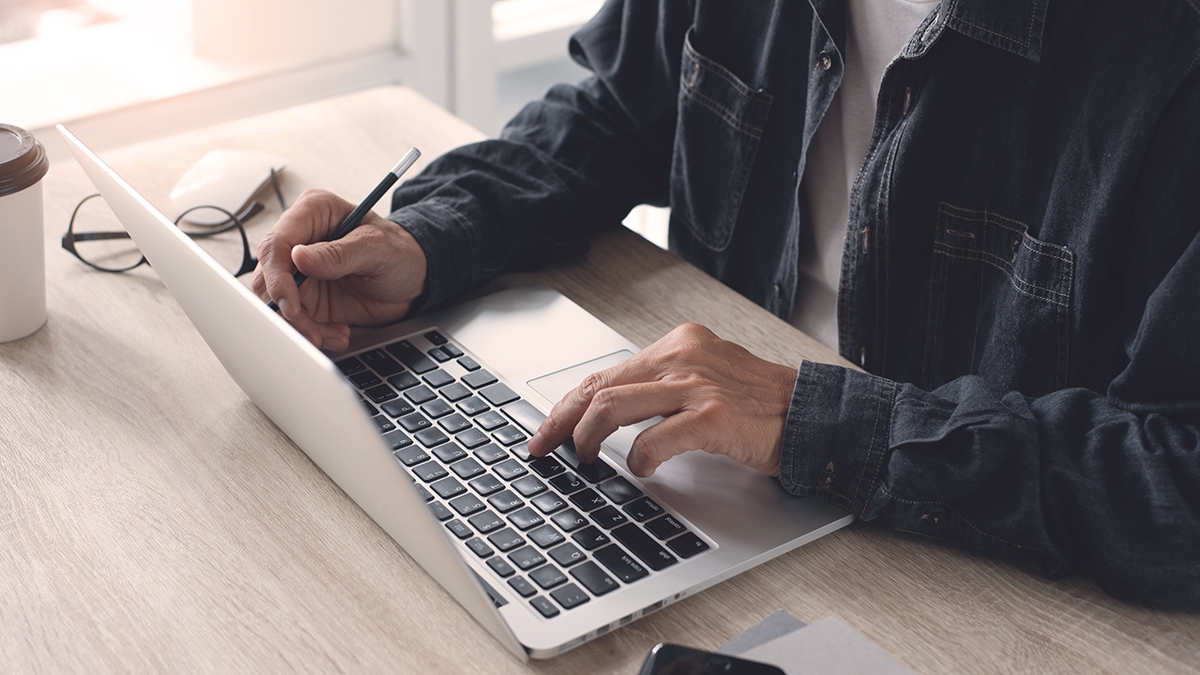 a person typing on a laptop