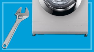 bottom of a washing machine next to a shifting spanner