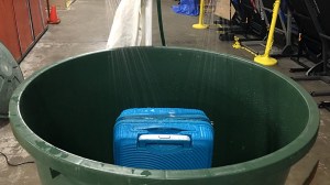 carry on suitcase being tested in shower rig