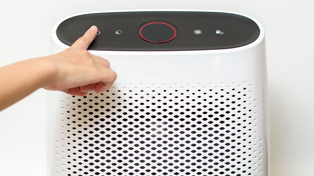 woman using air purifier