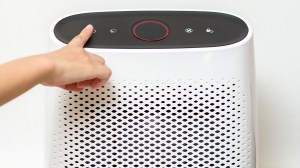 woman using air purifier