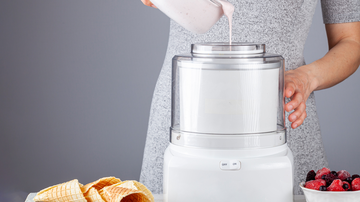 pouring cream into an ice cream maker