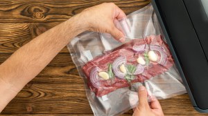 using a vacuum sealer to seal meat and herbs