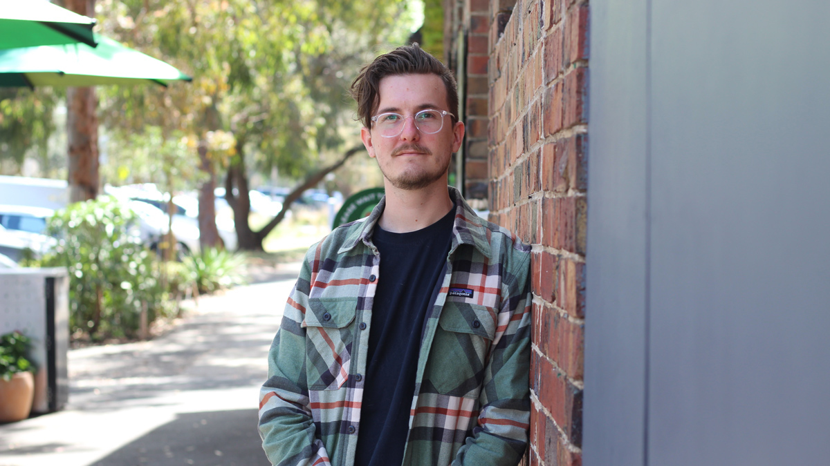 Jordie leaning against wall