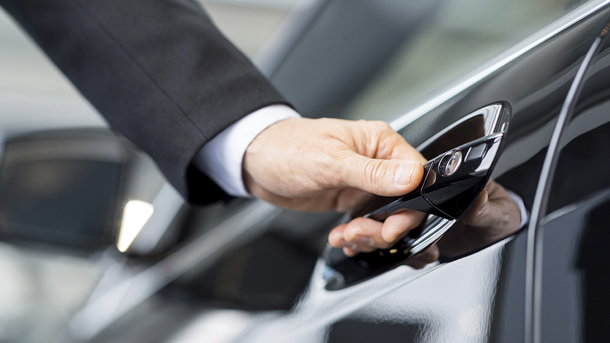 hand holding a car door opener