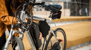 woman adjusting the battery on an electric bike