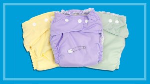 pastel coloured reusable cloth nappies on a blue background