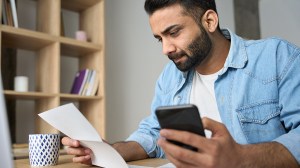 person looking at their superannuation account statement and about to call their super fund