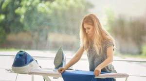 woman using steam station type iron