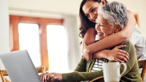 young adult with parent looking at a computer