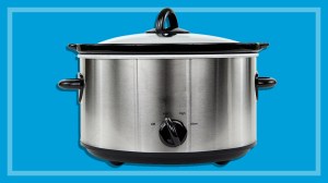 silver electric slow cooker on a blue backround