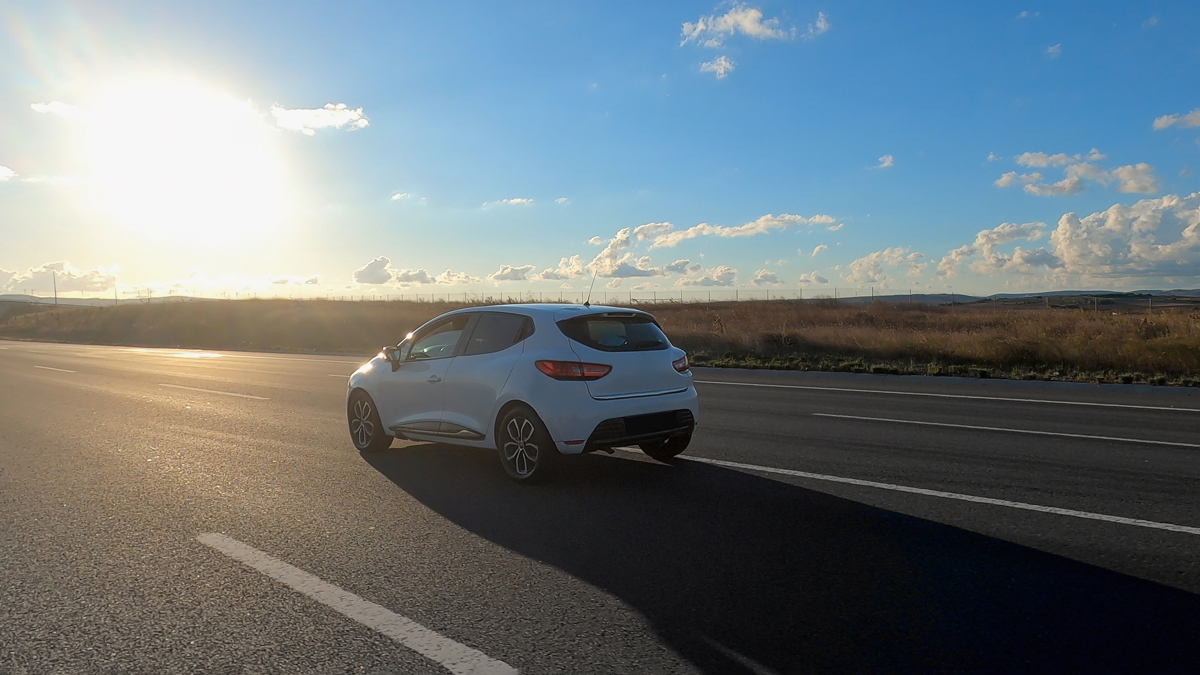 electric car driving on a freeway on a sunny day