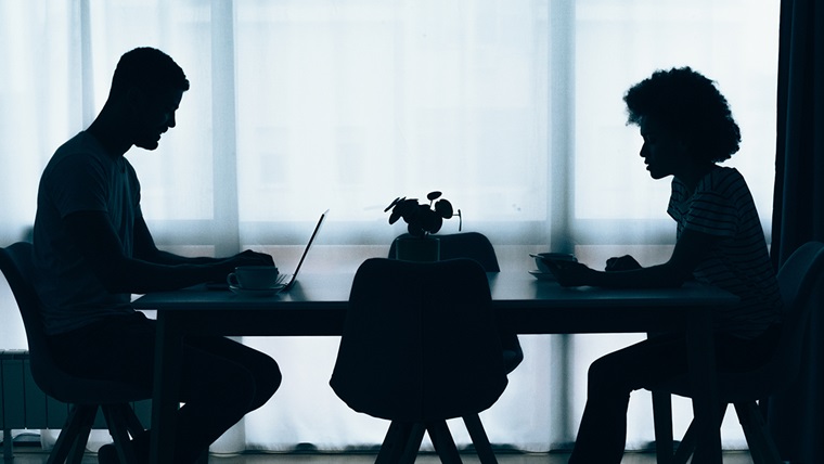 silhouette of couple at dining table and working on a laptop smsf